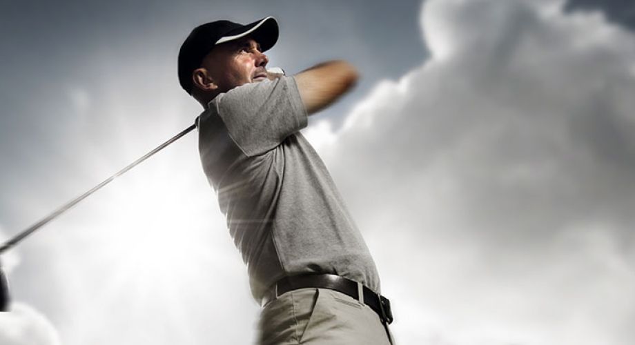 A golfer swings their club
